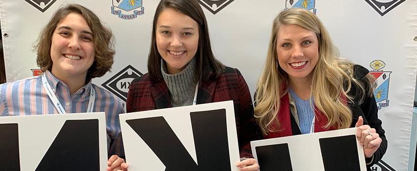 Three female students holding HKN Sign