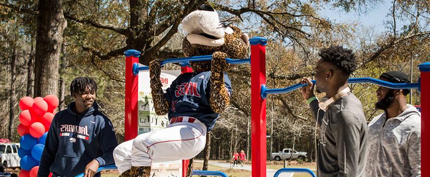 Southpaw with students doing pull ups on the Jag Fitness Trail.