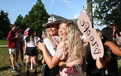 Two sorority girls hugging on bid day.